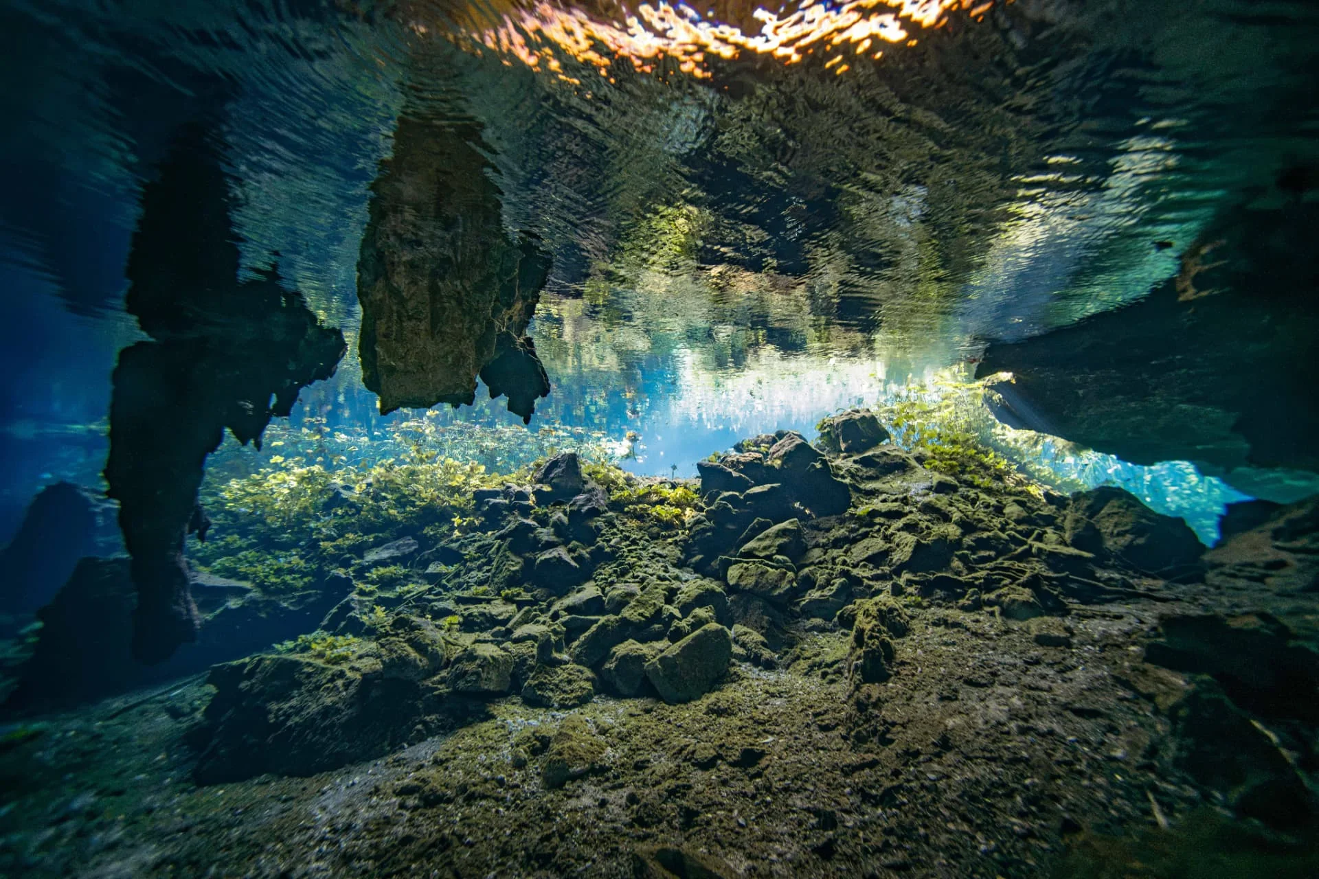 Rocky underwater floor reflected across the calm surface at Nicte-Ha