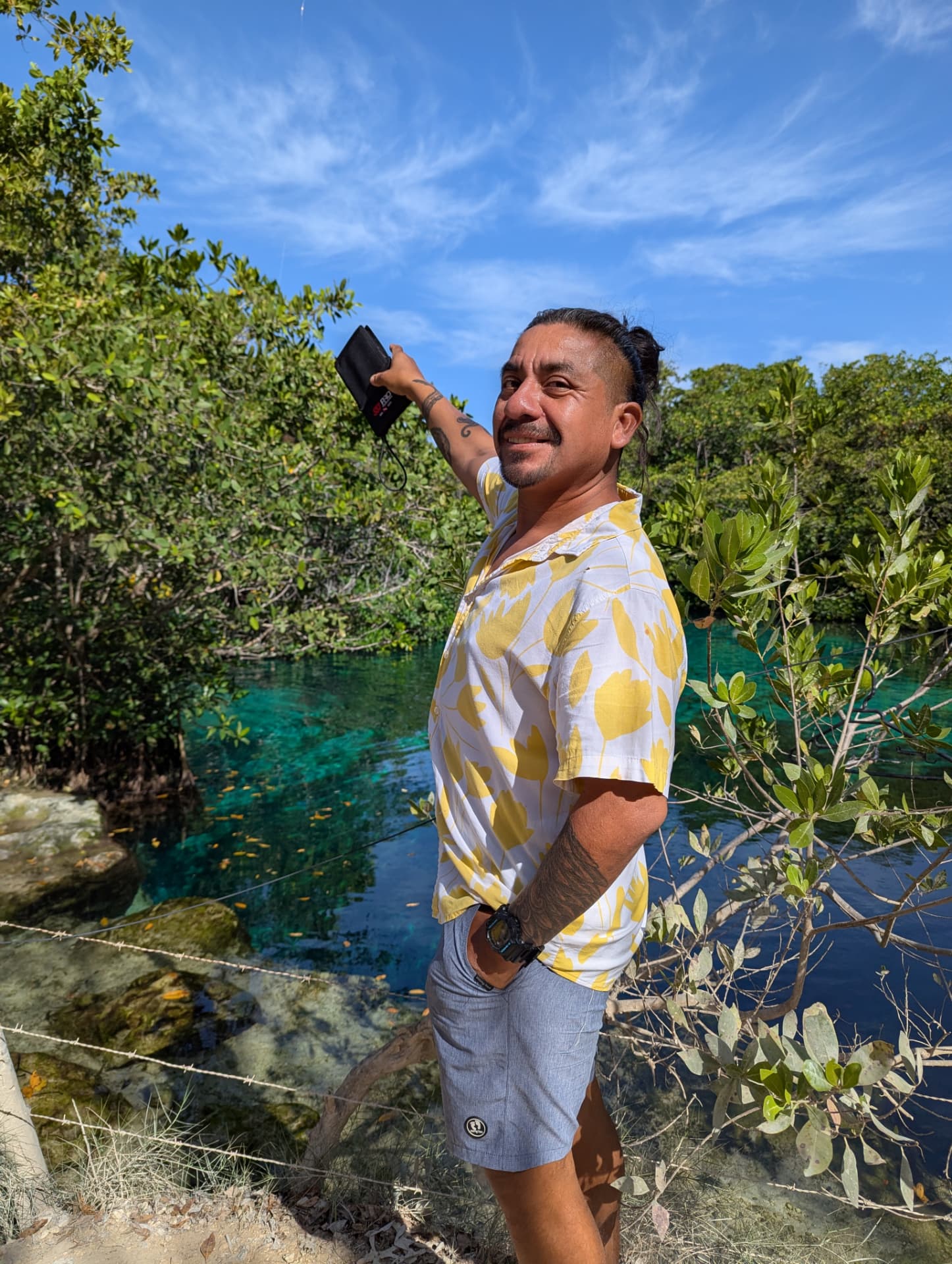Rubiel Estrada, SCUBAZTEC dive guide, beside a turquoise cenote in the jungle near Tulum, Mexico